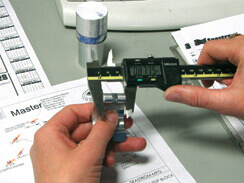 employee examining a manufactured part